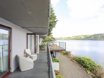 a porch of a house with a view of a lake at Tegid Lakeside - Bala Lake in Bala