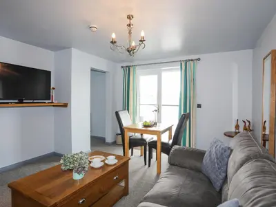 a living room with a couch and a table at Tegid Lakeside - Bala Lake in Bala