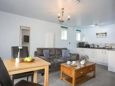 a living room with a couch and a table at Tegid Lakeside - Bala Lake in Bala