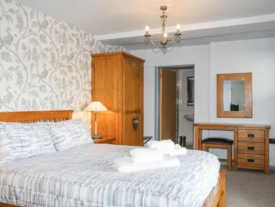 a bedroom with a bed with towels on it at Tegid Lakeside - Bala Lake in Bala