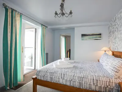 a bedroom with a bed and a window at Tegid Lakeside - Bala Lake in Bala