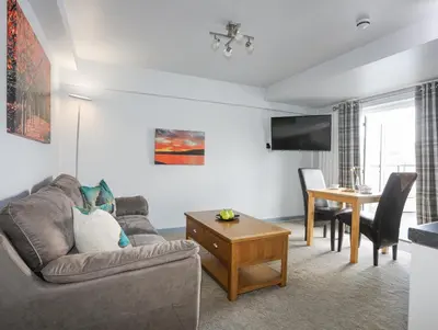 a living room with a couch and a table at Drysgol Lakeside - Bala Lake in Bala