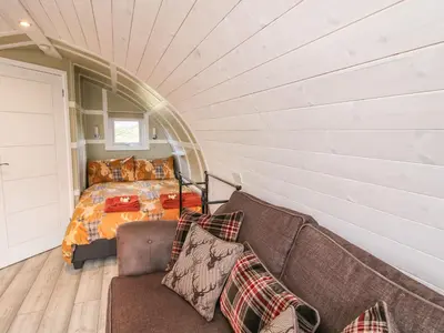 a living room with a couch and a bed at Cherry Pod 2 in Shrewsbury