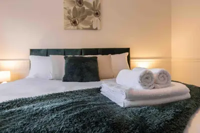 a bedroom with a bed with towels on it at Spacious house in quiet cul-de-sac near to Hospital in Shrewsbury
