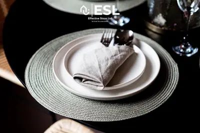 a plate with a fork and a napkin on a table at Elegant Apartment on Historic Cobbled High St Shrewsbury Town Centre in Shrewsbury