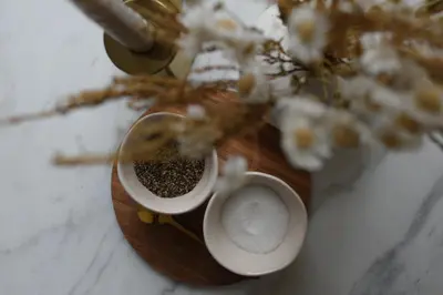a table with two bowls of seeds and a plant at Elegant Apartment on Historic Cobbled High St Shrewsbury Town Centre in Shrewsbury
