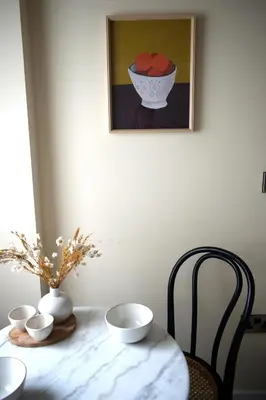 a table with a vase and bowls on top of it at Elegant Apartment on Historic Cobbled High St Shrewsbury Town Centre in Shrewsbury