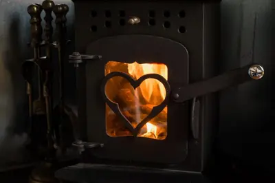 a heart drawn on the front of an oven at Shire the Shepherd's Hut at Pentref Luxury Camping in Penuwch