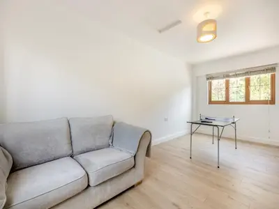 a living room with a couch and a table at Dyffryn Cain in Aberystwyth