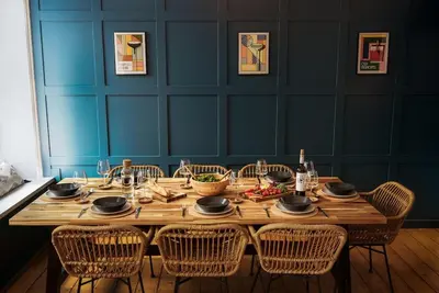 a dining room table with chairs and a wooden tableablish at Loft Fawr in Tregaron