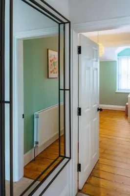 a mirror on a door in a room at Loft Fawr in Tregaron