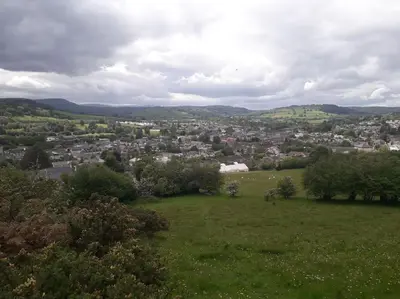 a green field with a city in the distance at Top Floor at Cantref House in Brecon
