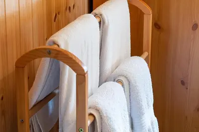 a towel rack in a bathroom with white towels at Pant in Llanymawddwy