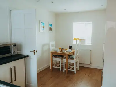 a small kitchen with a table and a microwave at The Coach House Barn in Shrewsbury