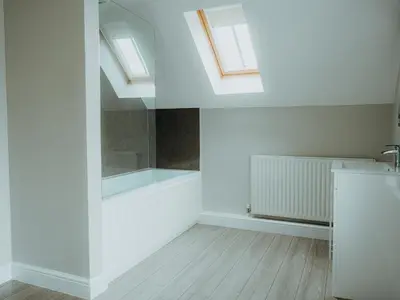 a bathroom with white walls and skylights and a sink at The Coach House Barn in Shrewsbury