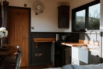 a kitchen with a sink and a stove at The Ginger Nut in Welshpool