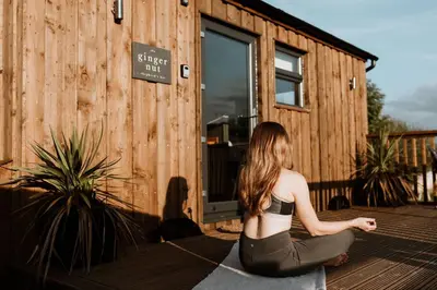 a woman sitting in a yoga pose in front of a building at The Ginger Nut in Welshpool