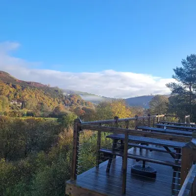 a wooden deck with a view of a valley at The Berwyn Arms in Corwen