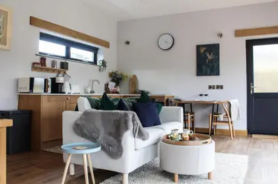 a living room with a couch and a table at The Tin Shed in Rhayader