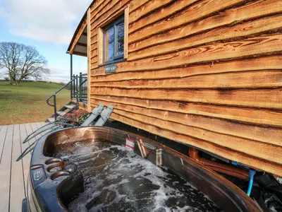 a house with a water tank next to a building at Wild Acre in Llangadog