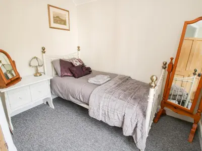 a bedroom with a bed and a dresser and a mirror at The Ferns in Ludlow
