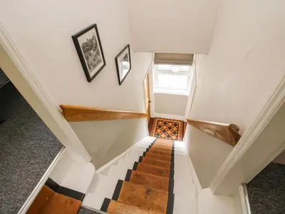 a staircase in a house with a checkered floor at The Ferns in Ludlow