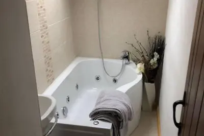 a white bath tub in a bathroom with a sink at 3-Bed Cottage Near Lake Vyrnwy Garden & PetsOk in Hirnant