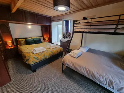 a bedroom with two beds and a bunk bed at Cringoed House in Aberaeron
