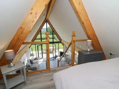 a bedroom with a bed and a large window at Brecknock Cheviot - The Sheepfold in Llandrindod Wells