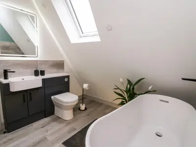 a bathroom with a toilet and a sink and a skylight at Brecknock Cheviot - The Sheepfold in Llandrindod Wells