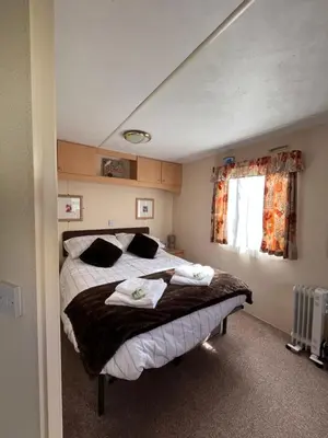 a bedroom with a bed with towels on it at welcome to B4 in Aberystwyth