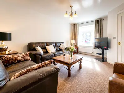a living room with a couch and a table and a tv at Town Location for Shrewsbury with 3 Bedrooms - Pass the Keys in Shrewsbury