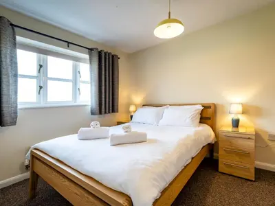 a bedroom with a large bed with two towels on it at Town Location for Shrewsbury with 3 Bedrooms - Pass the Keys in Shrewsbury