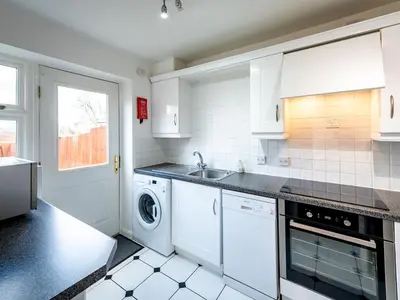 a white kitchen with a sink and a dishwasher at Town Location for Shrewsbury with 3 Bedrooms - Pass the Keys in Shrewsbury