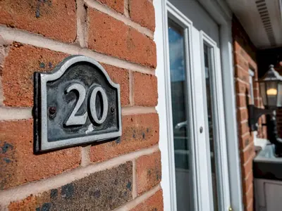 a sign on a brick wall with the number twenty at Town Location for Shrewsbury with 3 Bedrooms - Pass the Keys in Shrewsbury