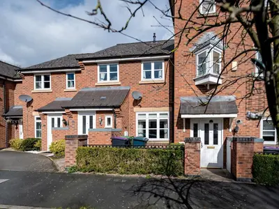 a brick house with white windows and a driveway at Town Location for Shrewsbury with 3 Bedrooms - Pass the Keys in Shrewsbury