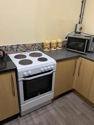 a kitchen with a white stove and a microwave at Llanfyllin Workhouse - Y Dolydd in Llanfyllin