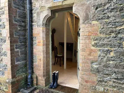 an entrance to a brick building with an archway at Trillow House, Clungunford, Ludlow in Clungunford