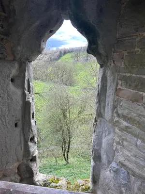a window in a stone building with a view of a field at Trillow House, Clungunford, Ludlow in Clungunford