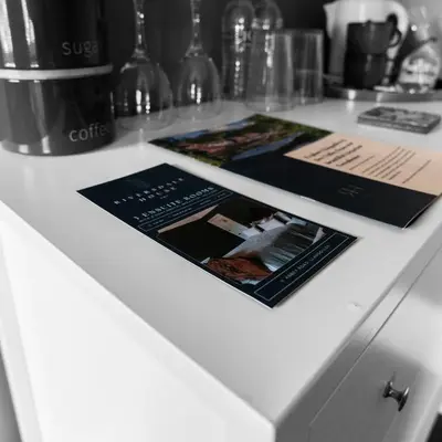 a counter with three brochures on top of it at Riversdale House Bed & Breakfast in Llangollen