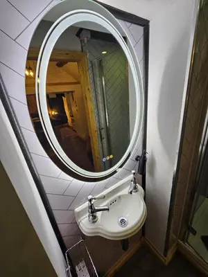 a bathroom with a sink and a mirror at Romantic Hideaway in Trawsfynydd