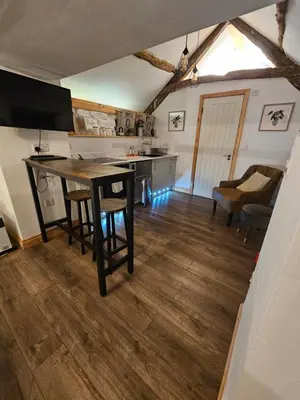 a kitchen with a table and chairs in a room at Romantic Hideaway in Trawsfynydd