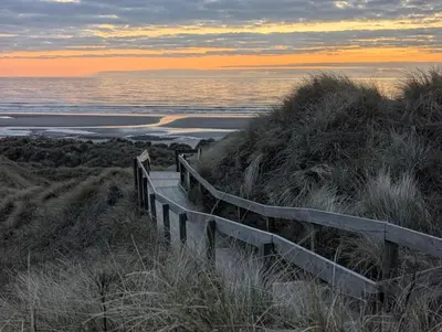 a wooden stairway to the beach at sunset at Peacehaven, Ynyslas, Borth in Borth