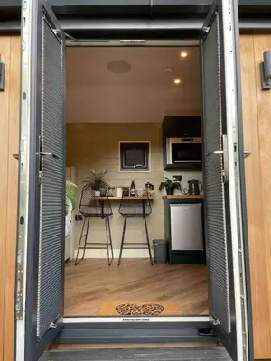an open door to a kitchen with a table at Dee Lodge with private hot tub in Llangollen