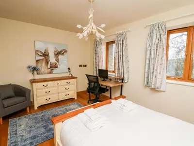 a bedroom with a bed and a desk and a chair at The Orchard in Knighton
