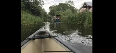 a girl in a boat on a river at Willowdene shepherds hut in Oswestry