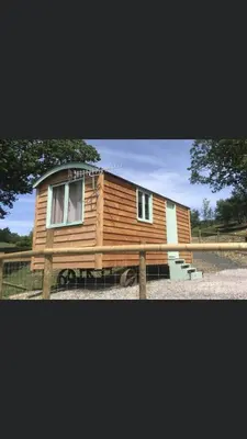 a wooden tiny house sitting on a trailer at Shepherds hut Lowri in Dolgellau