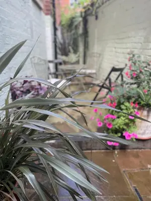 a group of chairs and flowers in a garden at St. John’s hill - with parking in Shrewsbury