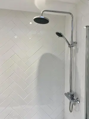 a shower with a shower head in a bathroom at St. John’s hill - with parking in Shrewsbury