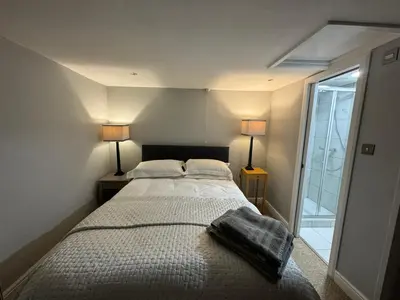 a bedroom with a bed with two lamps and a window at St. John’s hill - with parking in Shrewsbury